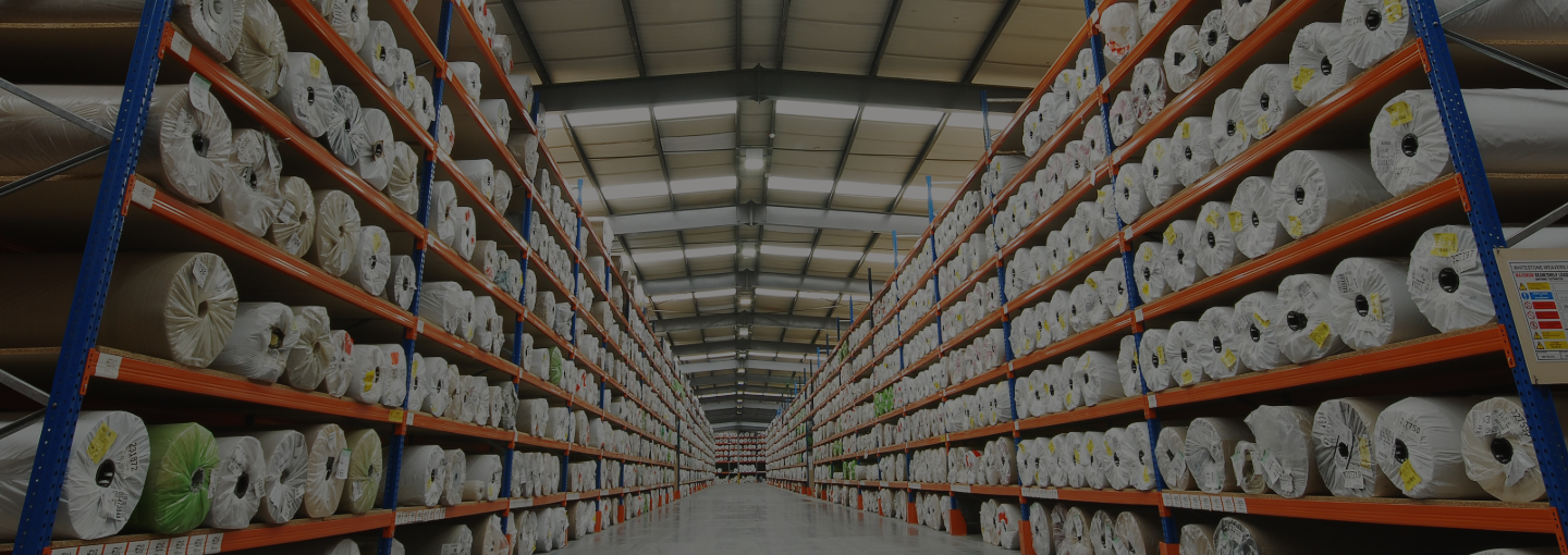 Carpet racking system in a warehouse used for storing rolled carpets and rugs